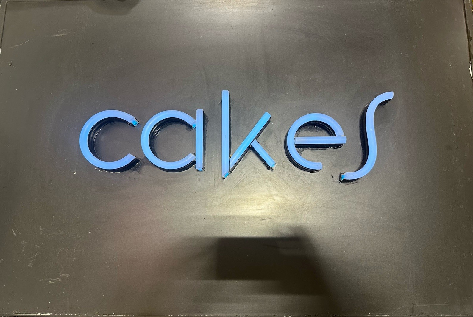 “Cakes” LED Sign L-30in W-1.5in H-20in (Blue Light Up)