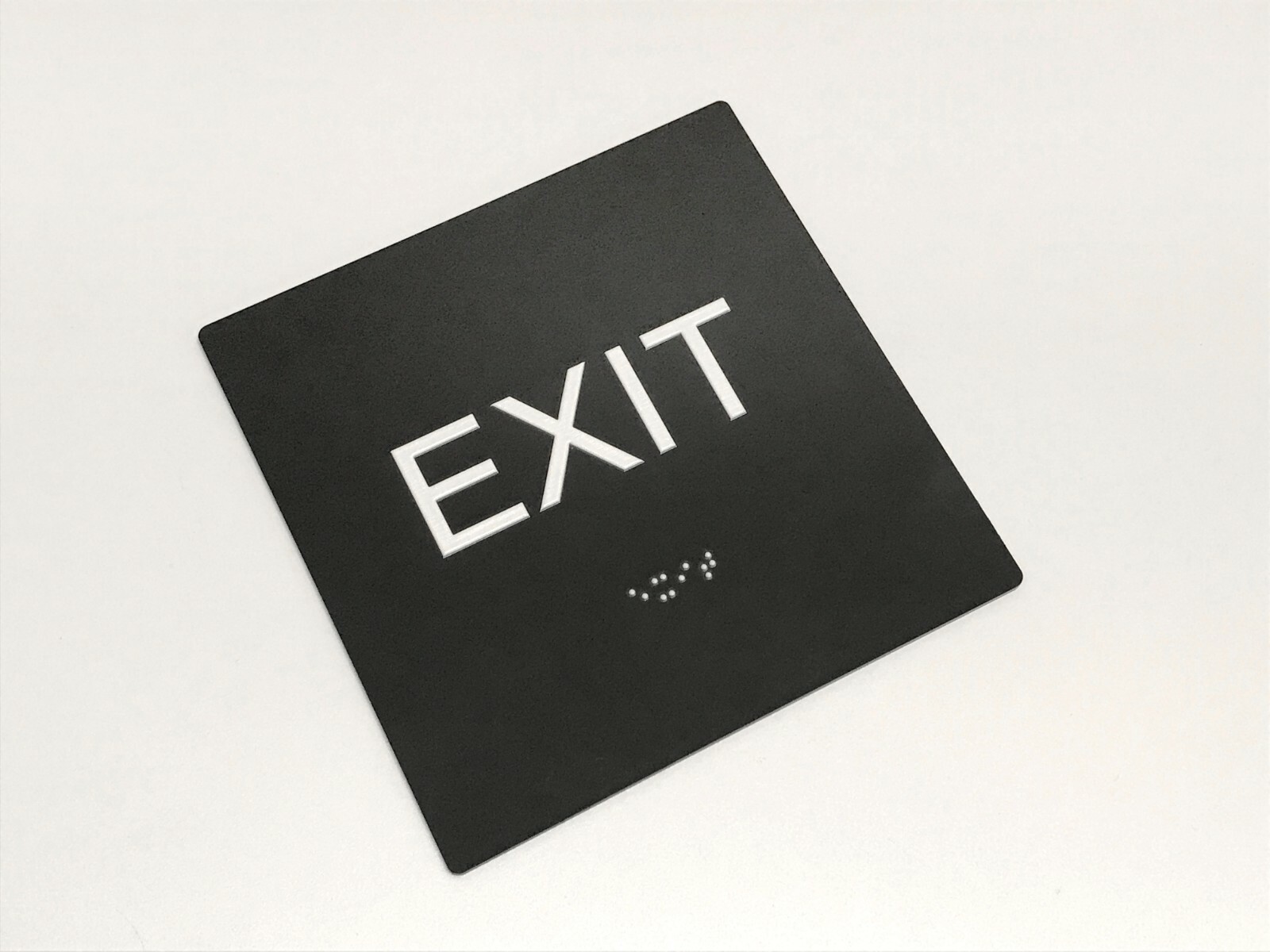 “EXIT” ADA / braille sign 4″ x 4″ matte black acrylic w/white tactile 