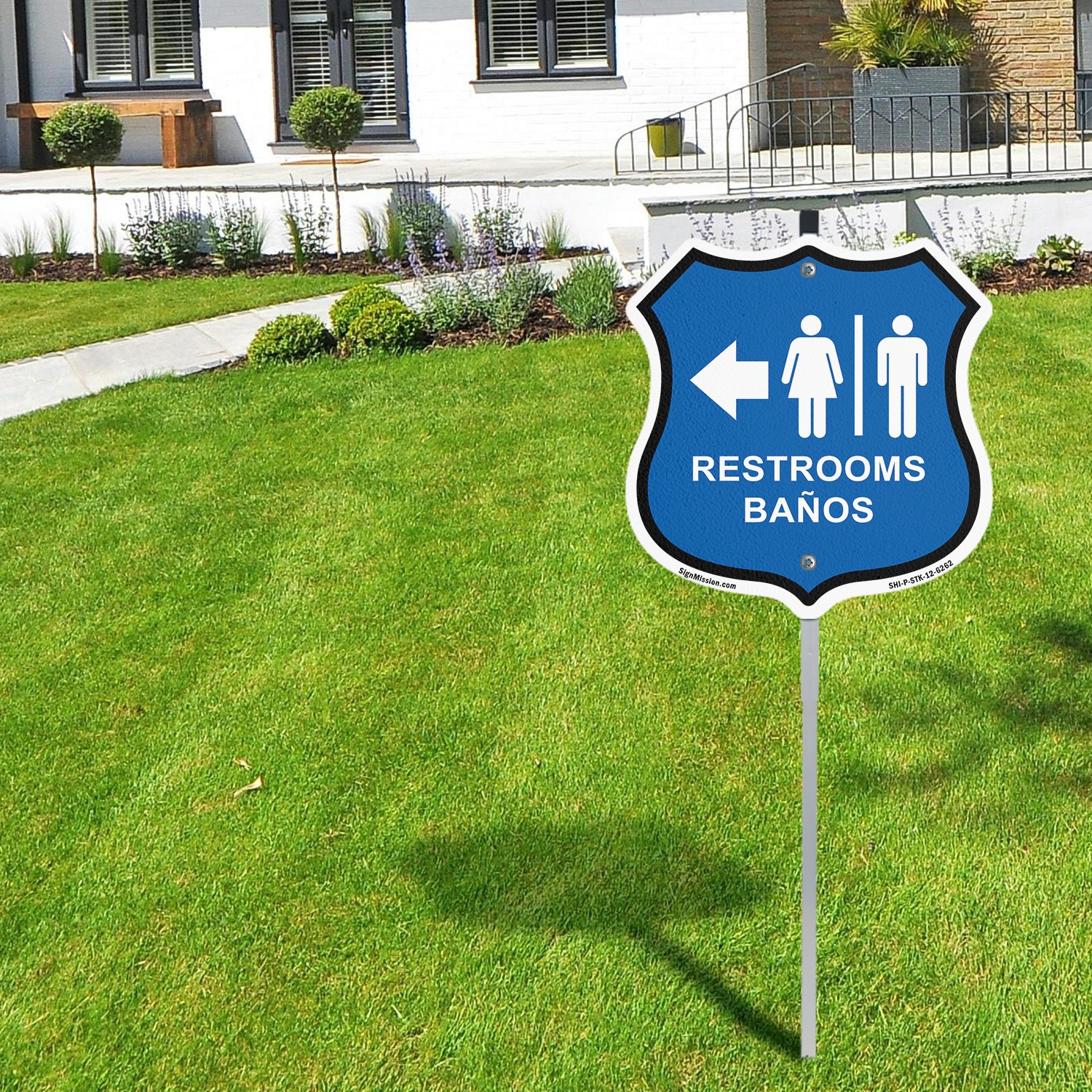 Restrooms Ba�os Left Arrow Bilingual English / Spanish Shield Sign With Stake